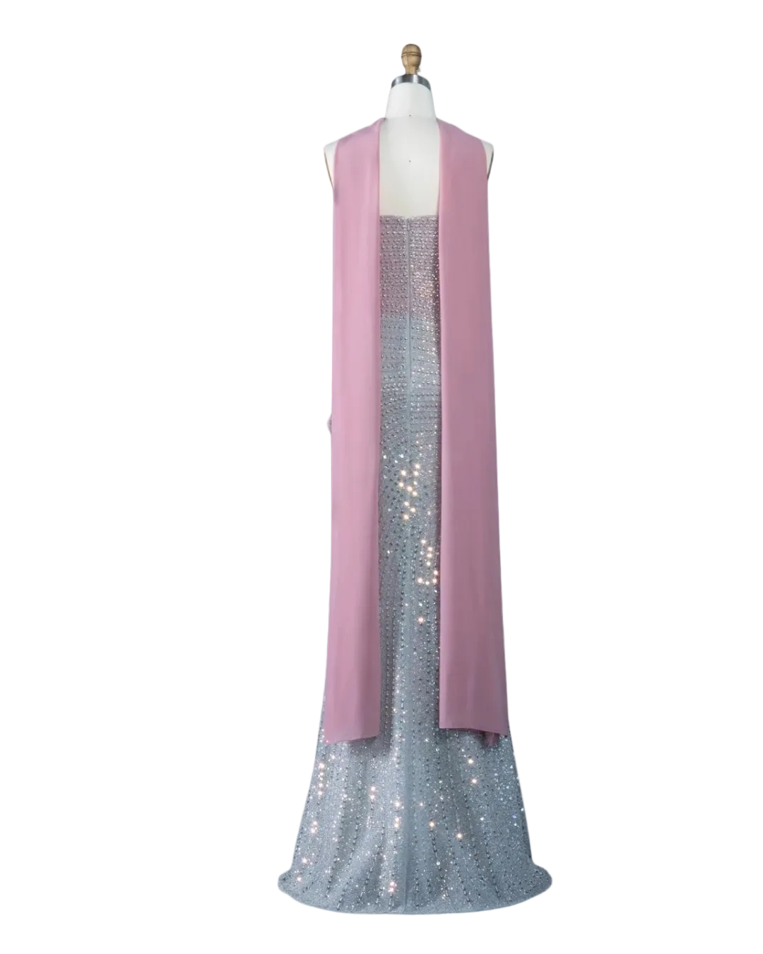 A sleeveless pink draped vest or shawl displayed on a mannequin over a sparkling silver sequined gown, shown against a pale blue background with the Riviera Board the Wanda logo in the top left corner.